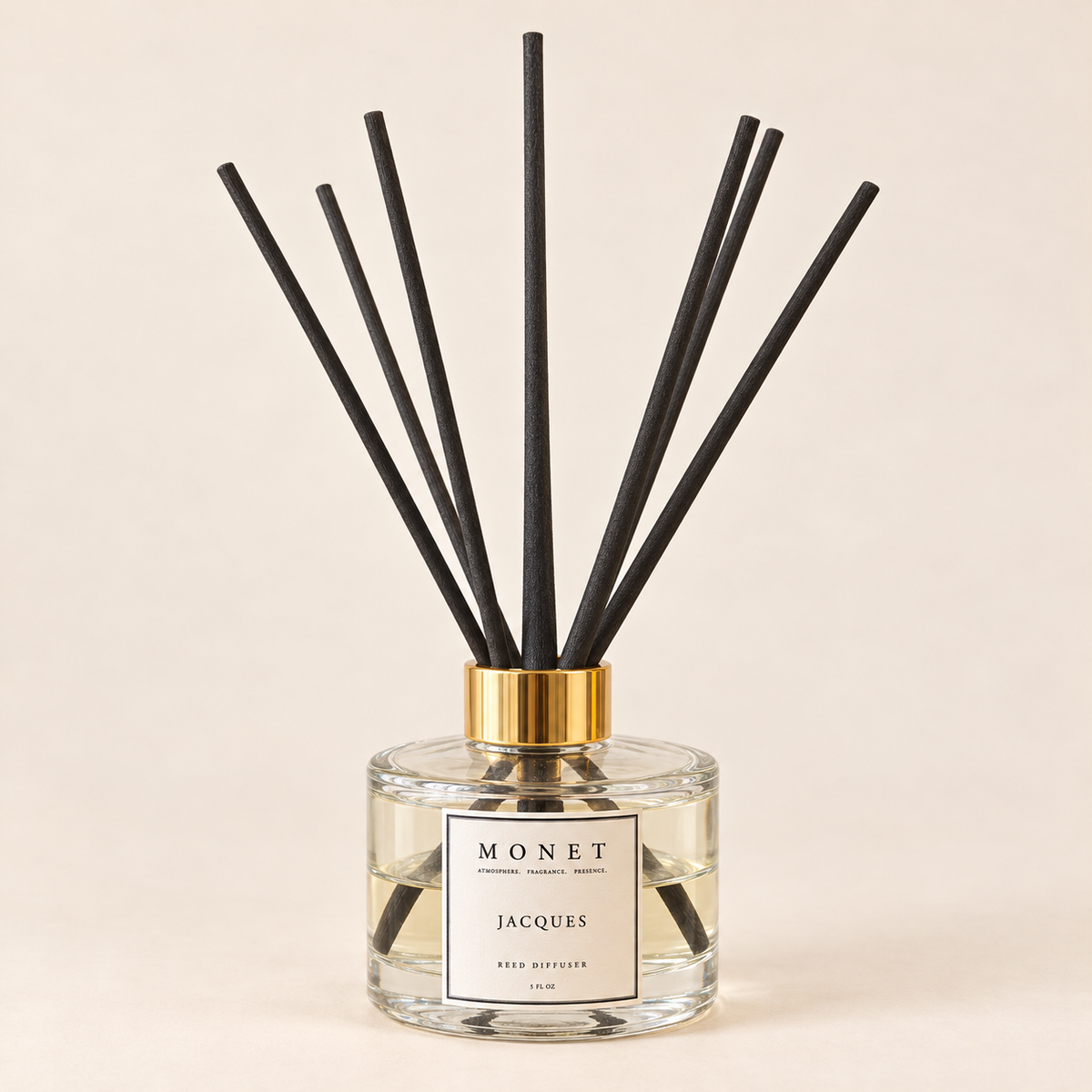Jacques — Reed Diffuser, current MONET bottle and seven dark reeds on warm ivory